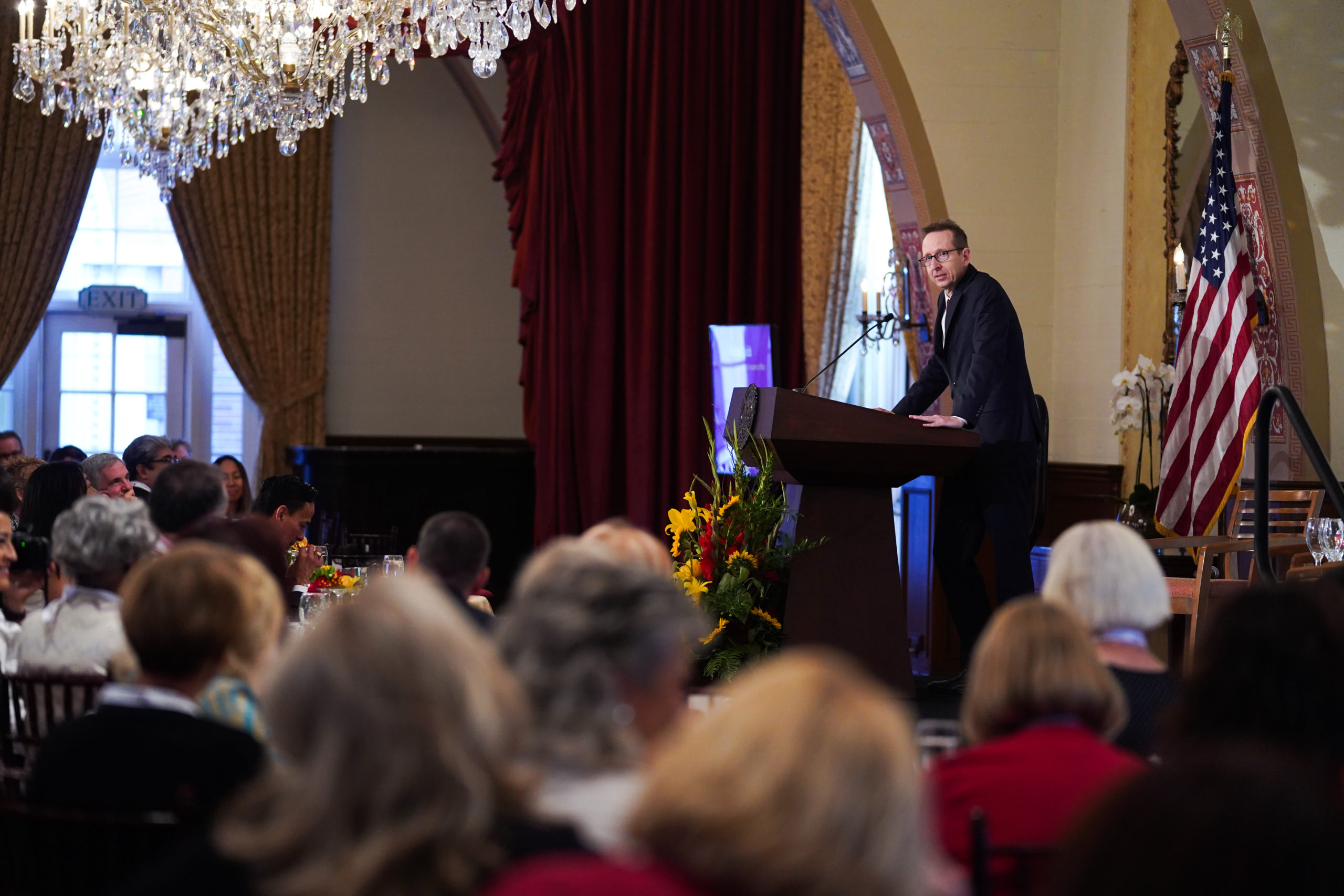 Provost Michael Quick speaking to an audience